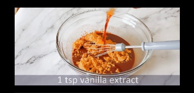 brown sugar and vanilla extract is added to melted chocolate in a glass bowl