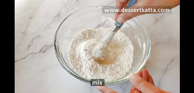 flour, baking powder and salt is mixed using whisk in a glass bowl.