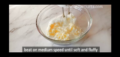 butter is sugar is mixed together in a glass bowl using hand beater