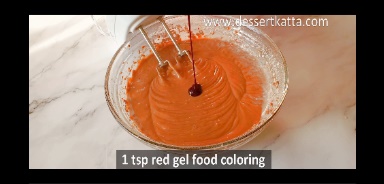 add red food coloring in cake batter in a glass bowl