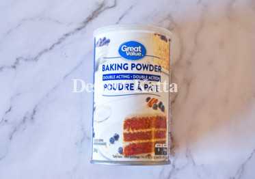 great value's baking powder tin placed on marble background