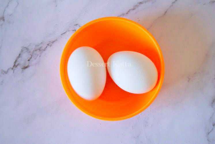 2 eggs are placed in orange bowl