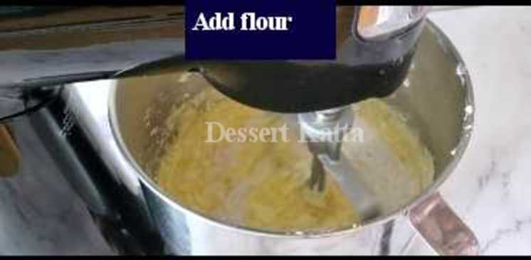 eggs are added to butter, sugar and egg batter in stand mixer.