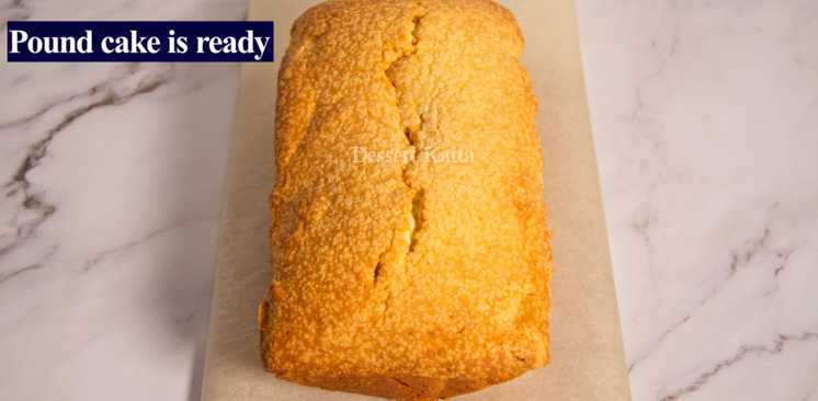 pound cake with perfect crack on top is placed on parchment paper