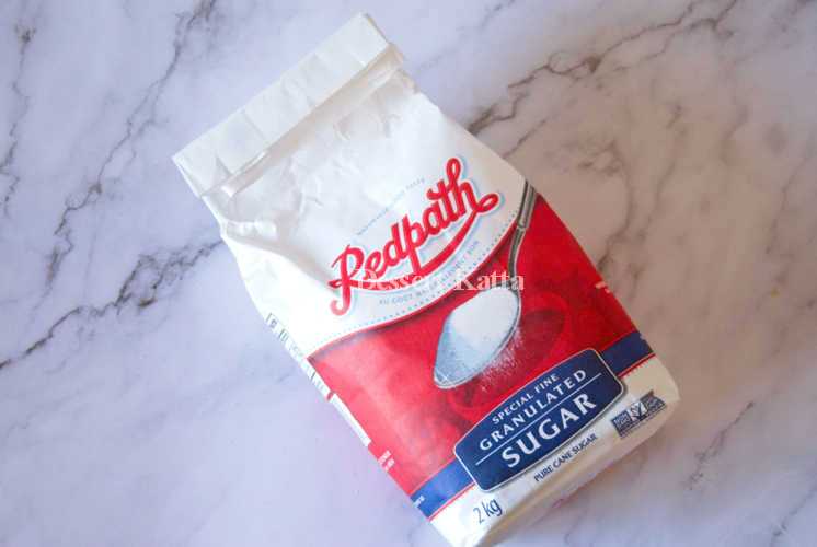 A 2 Kg bag of Redpath sugar is placed on marble surface