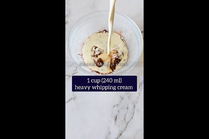 1 cup of heavy whipping cream is added to the glass bowl to make chocolate mousse with cocoa powder