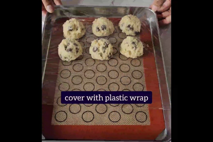 plastic wrap is covered over small cookie doughs