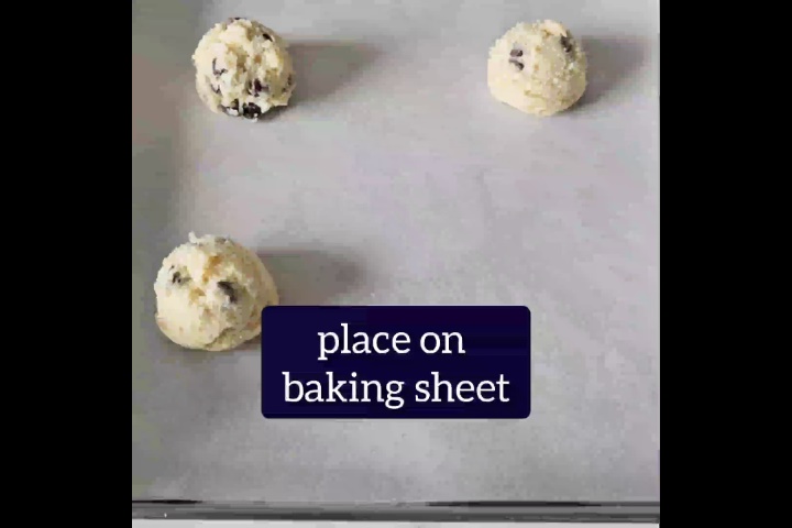 3 small round no brown sugar cookie dough balls are placed on baking sheet