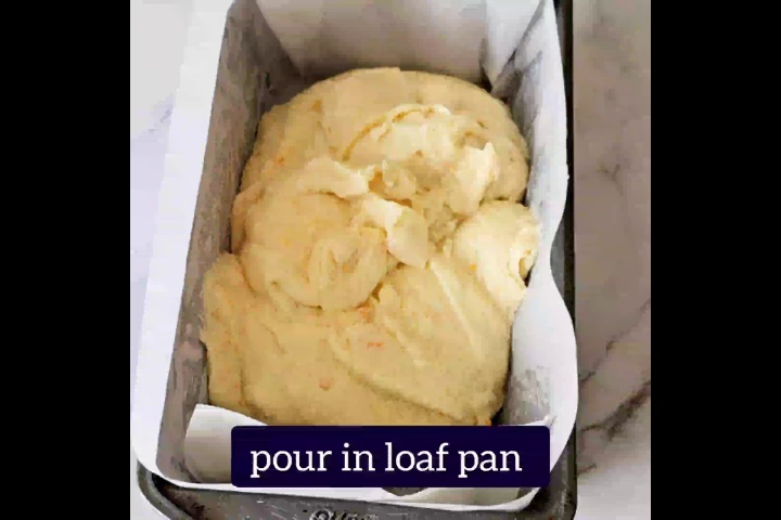 orange loaf cake batter is poured in loaf pan