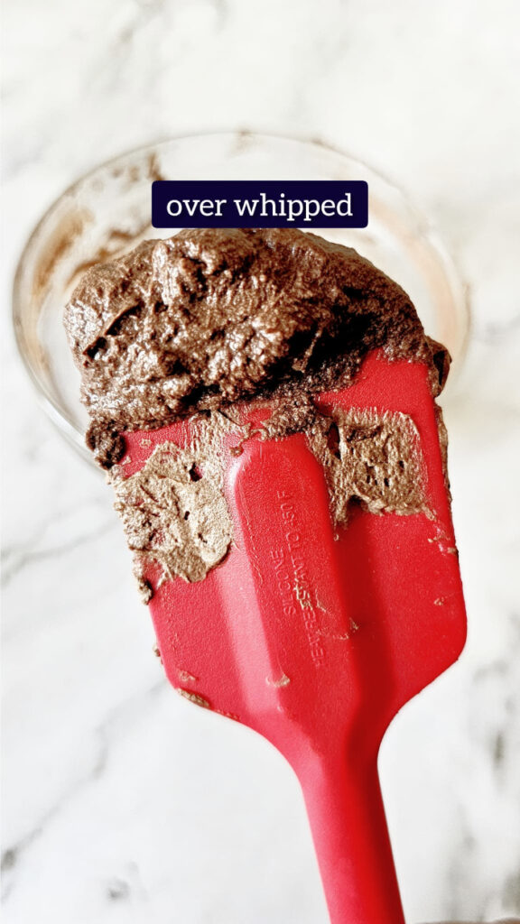 red spatula with over whipped cream chocolate mousse