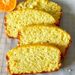 orange loaf cake slices kept on parchment paper