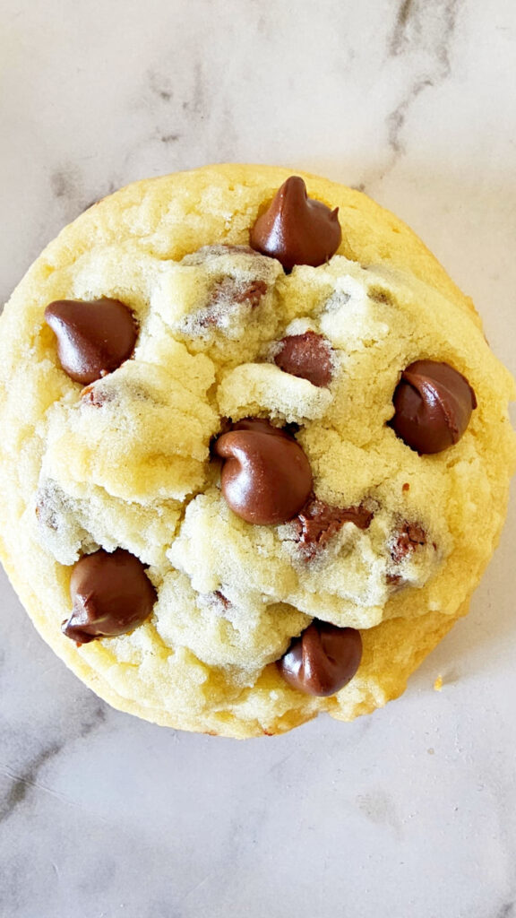 single no brown sugar cookie loaded with chocolate chips is placed on marble surface