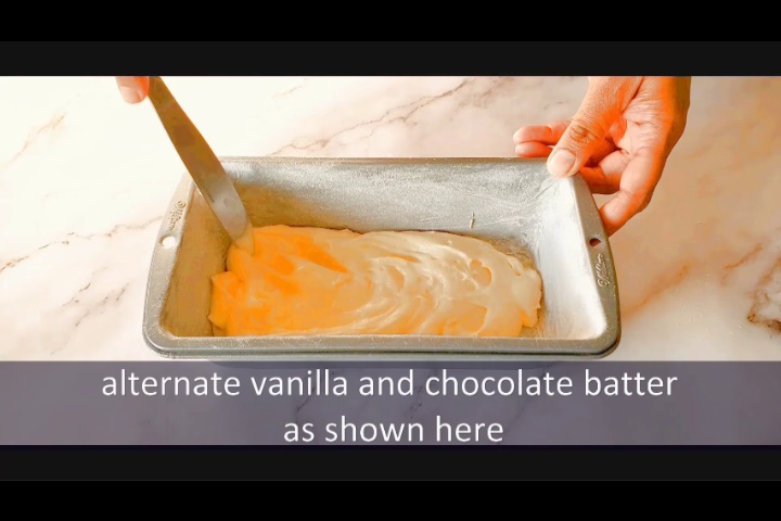 adding one layer of vanilla cake batter in 9X5 inch loaf pan while making marble loaf cake recipe