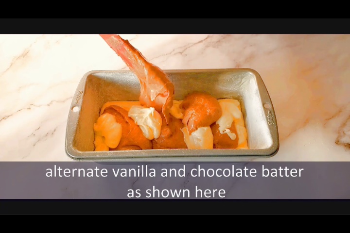 alternating vanilla and chocolate cake batter in 9X5 inch loaf pan while making marble loaf cake recipe