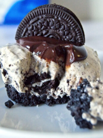 Mini Oreo Cheesecake topped with chocolate ganache and half Oreo cookie.