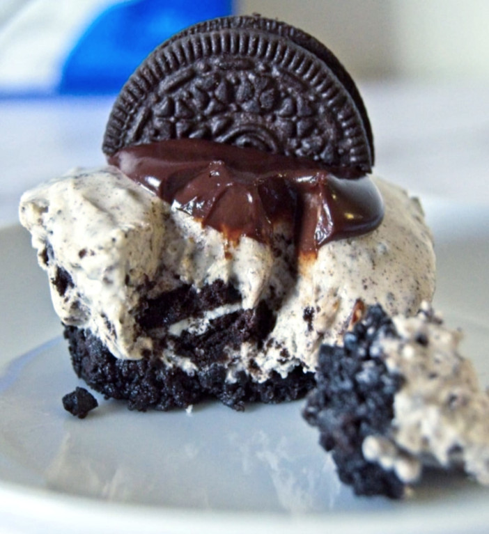 Mini Oreo Cheesecake topped with chocolate ganache and half Oreo cookie.