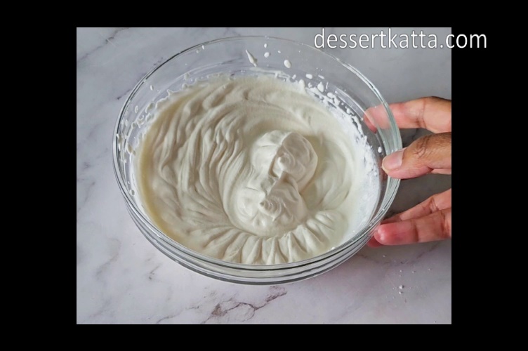 big mixing bowl contains whipped cream to make banana pudding recipe