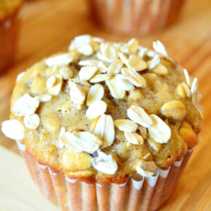 just baked banana oatmeal chocolate chip muffins topped with rolled oats