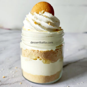 layered banana pudding with whipped cream and Nilla wafer on top