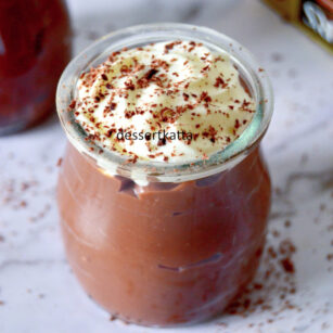 homemade chocolate pudding garnished with whipped cream and cocoa powder