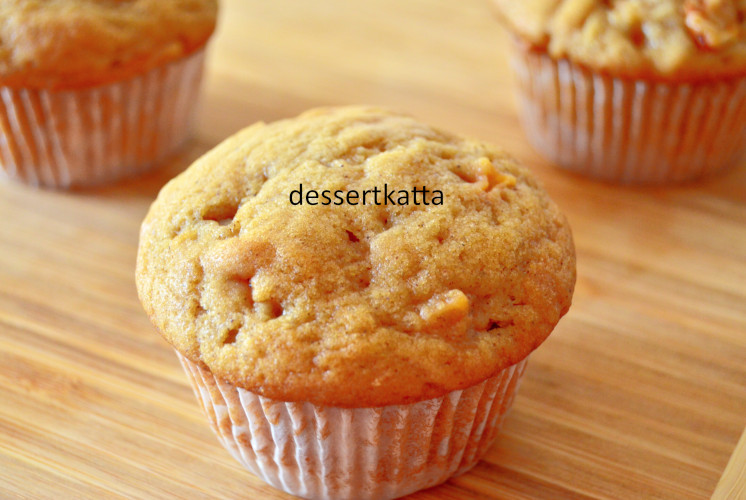 apple cinnamon muffins are placed on wooden board