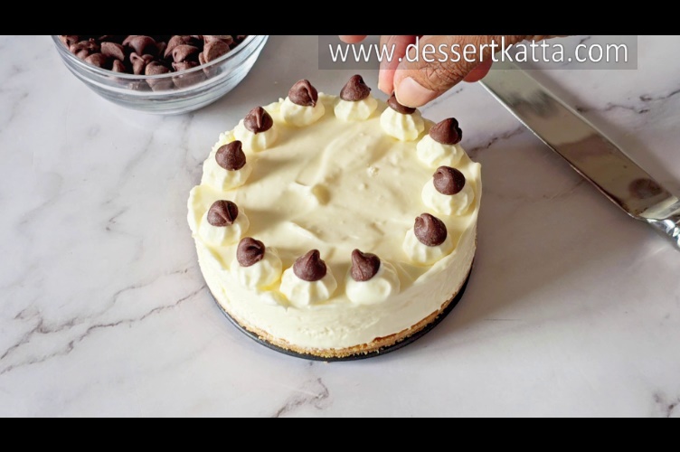 placing chocolate chips on 5-ingredient no bake cheesecake