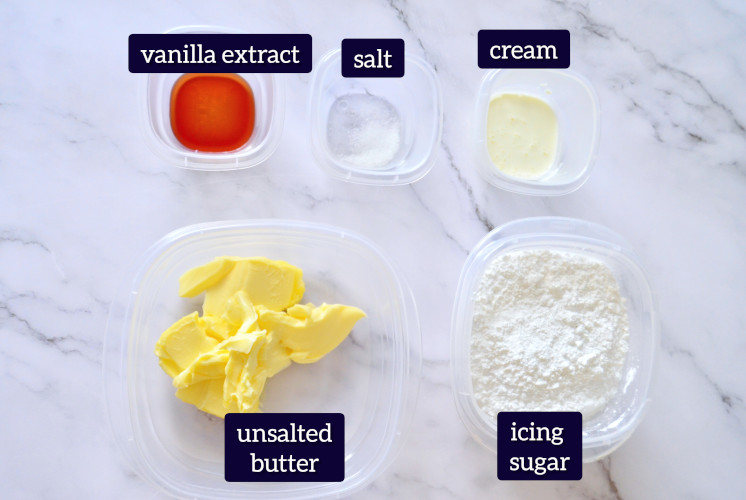 all of the ingredients to make American buttercream placed on marble surface