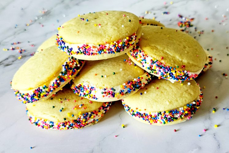 vanilla whoopie pies coated with sprinkles stacked over each other