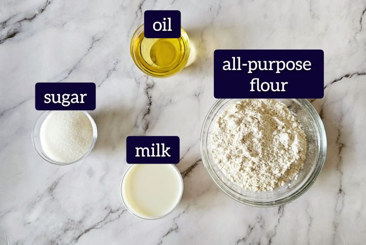 shot of all of the shankarpali ingredients placed in small bowls on marble surface