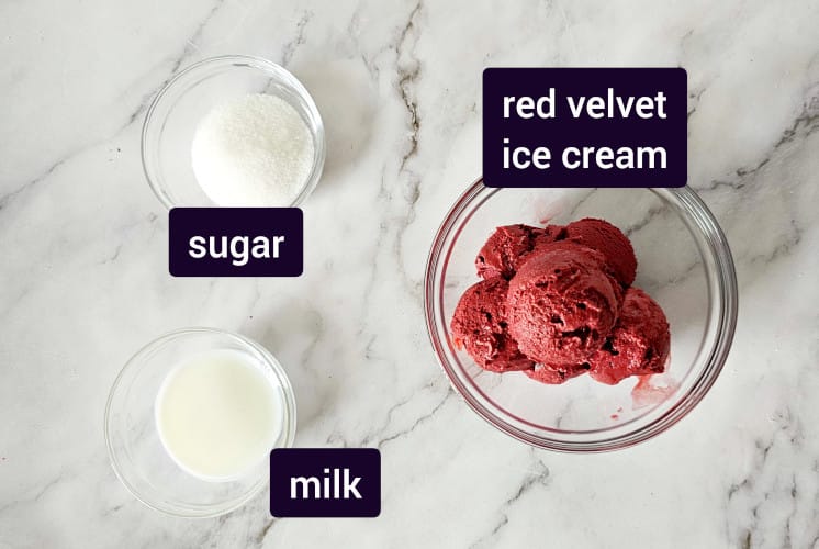 red velvet milkshake ingredients placed on marble surface