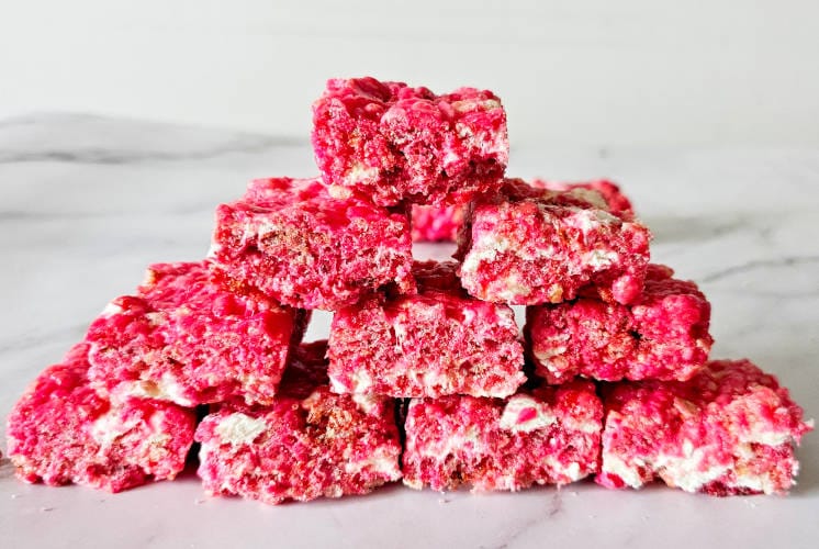 Starbucks rice krispie treats are stacked over each other on marble surface