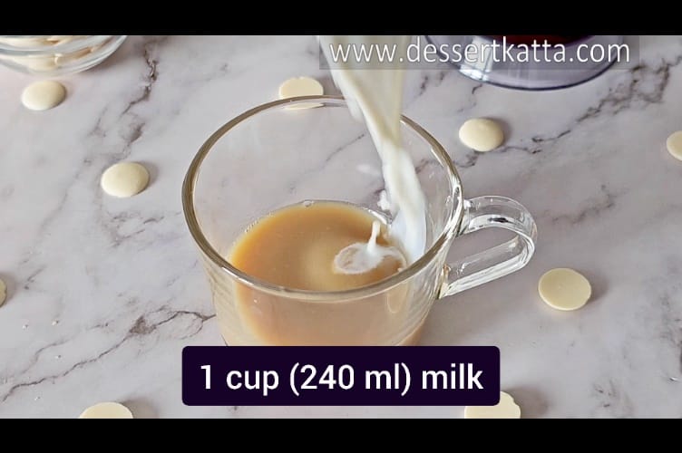 pouring frothed milk in a serving mug