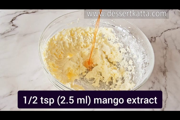 adding mango extract in mango buttercream