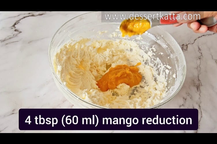 adding 60 ml of mango reduction in butter-sugar mixture