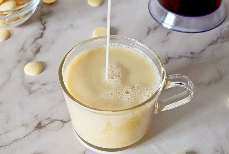 pouring milk to make white chocolate mocha from Starbucks